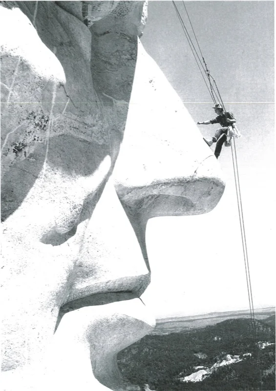 ( Herb Conn dangled from the faces on Mount Rushmore each fall to do maintenance work | U.S. Dept. of Interior)