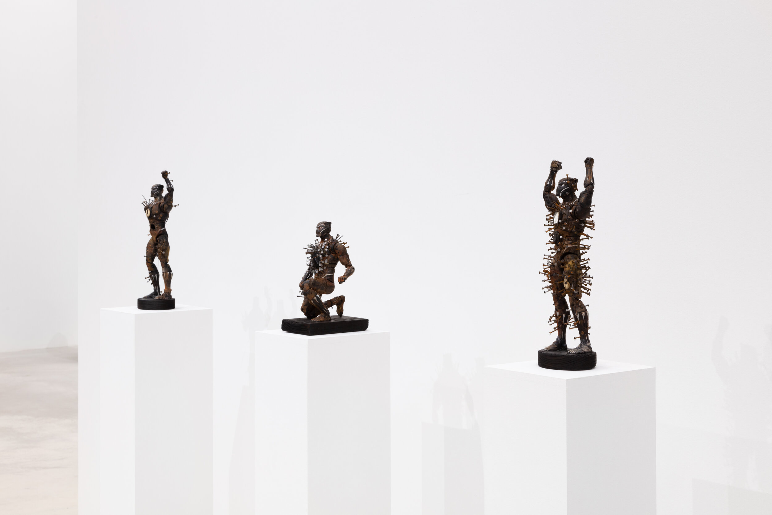  Install view - Power figure for the American Negro:  Black power fist, Taking a knee, Hands up 