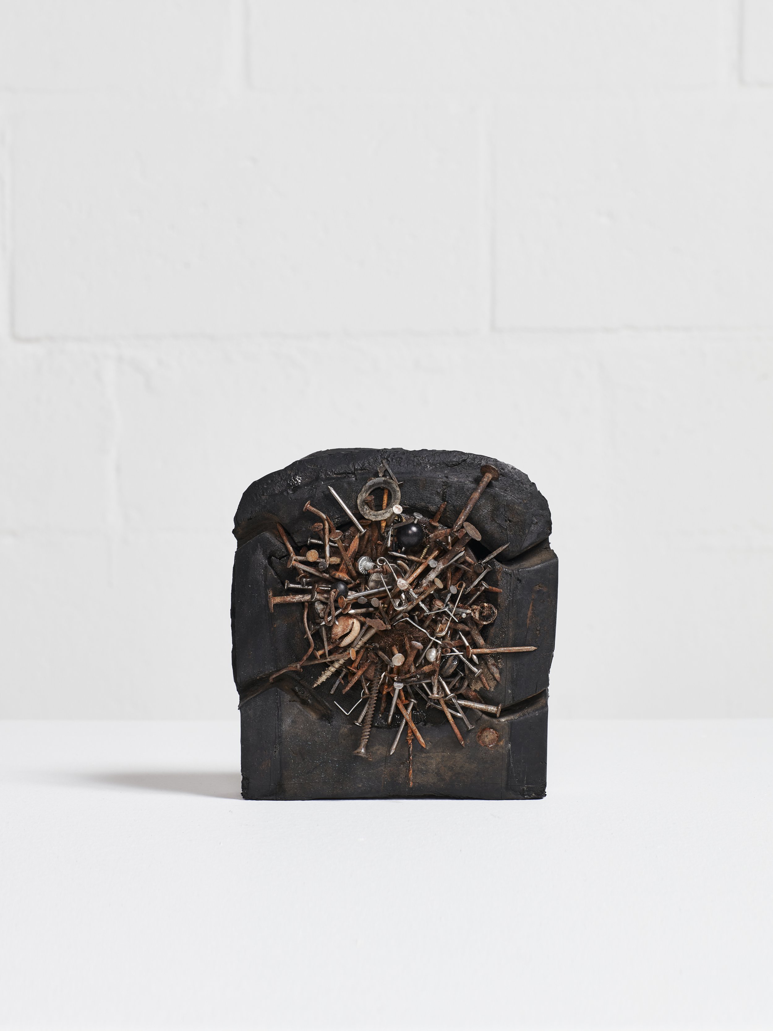  Black Manna, 2022  Rubber, found objects, nails, cowrie shell, hair  7 x 6 x 4.13 inches 
