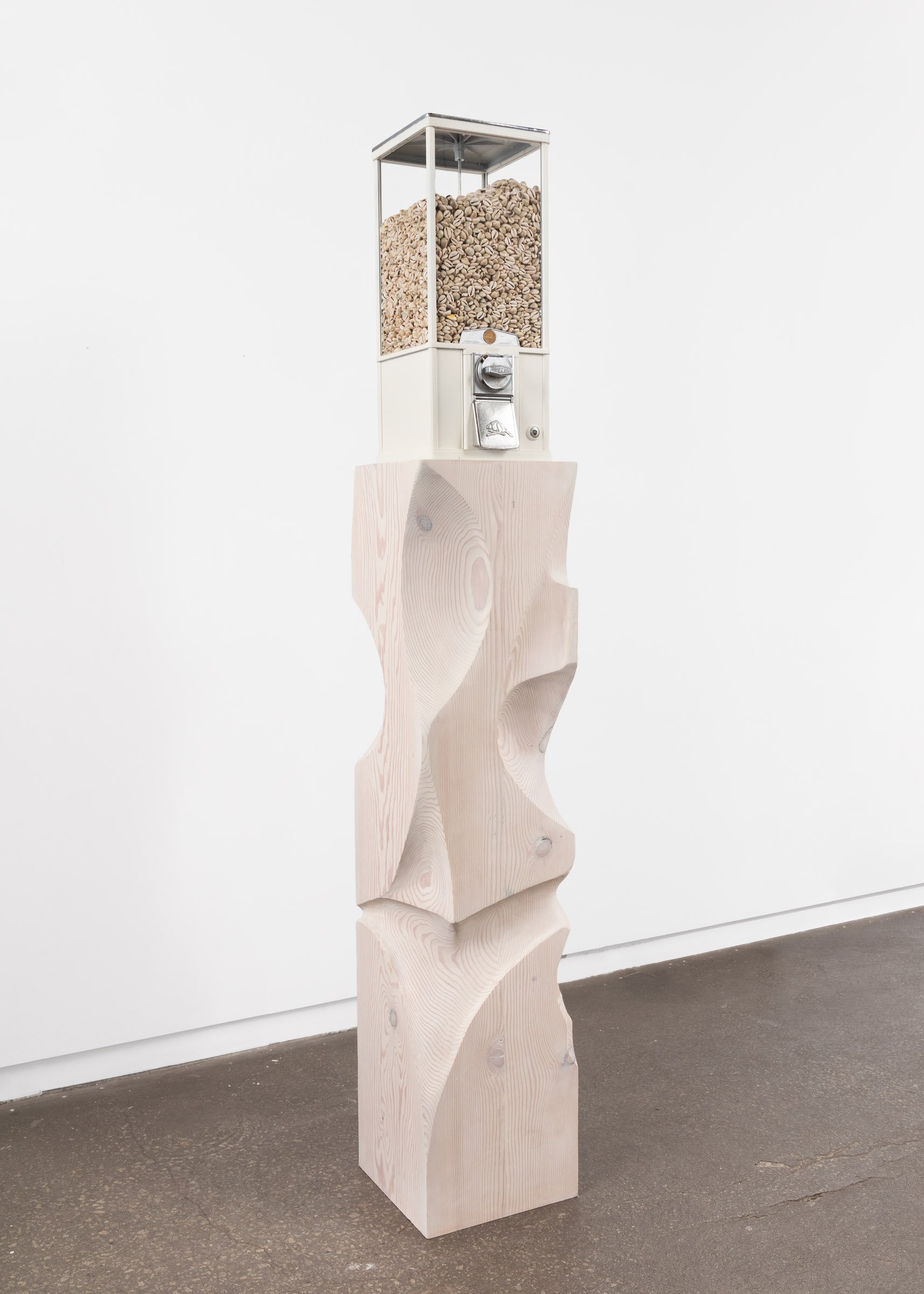  Good Luck Totem III (Dia de Oxalá)  Vending machine, cowrie shells, Douglas fir, Canadian loonie  78 × 13 × 13 inches 