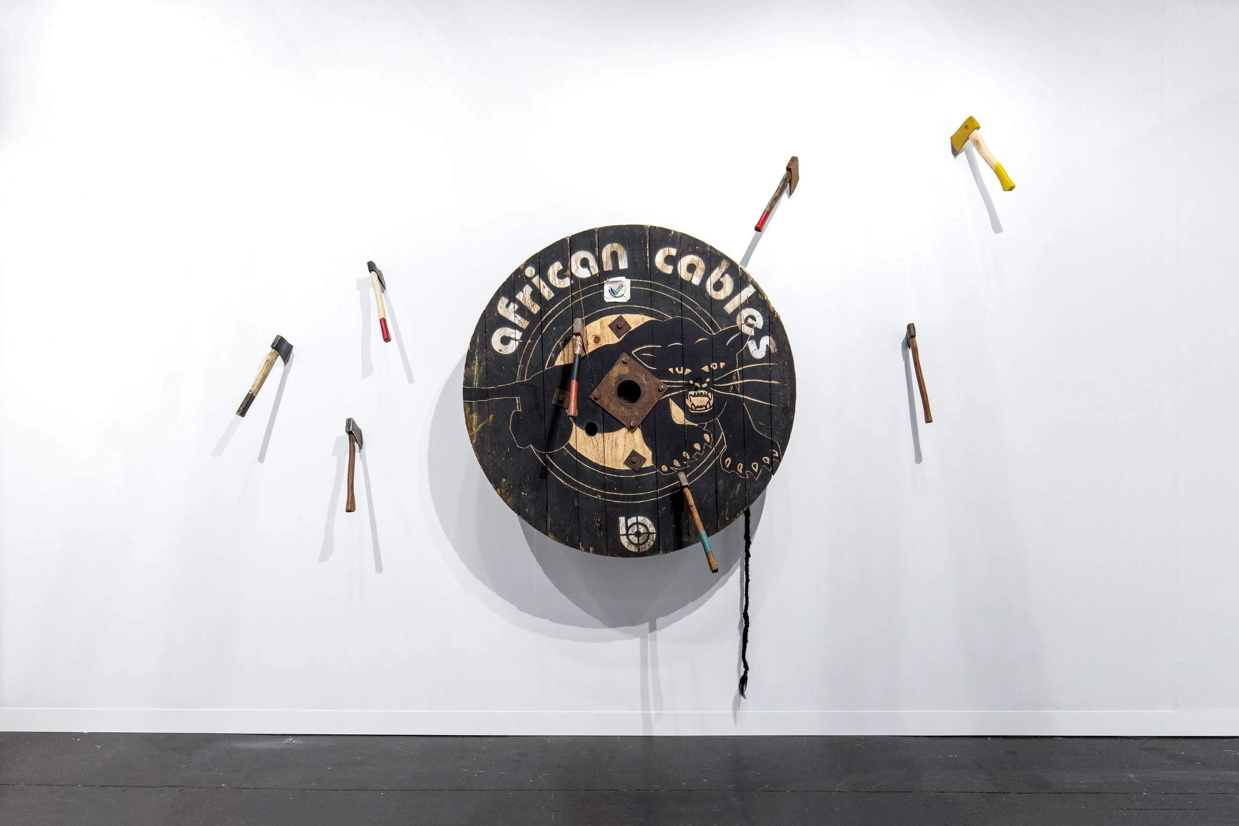  Ogun’s Eye, 2023  Carved cable reel, axes, gouache, synthetic hair fibre  Variable dimensions 