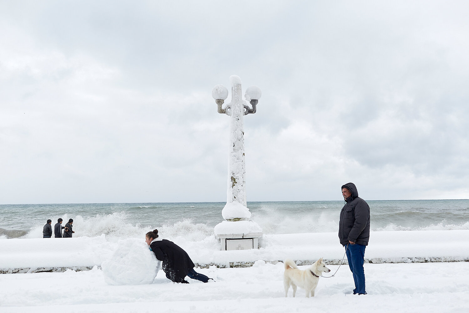  Abkhazia, Sukhum, 03/01/2016. It has been almost 8 years since the last big snowfall in Sukhum. Everybody was outside making a "snowman", playing snowballs or just walking through the snow. The girl on the picture is making a part of a big snowman. 