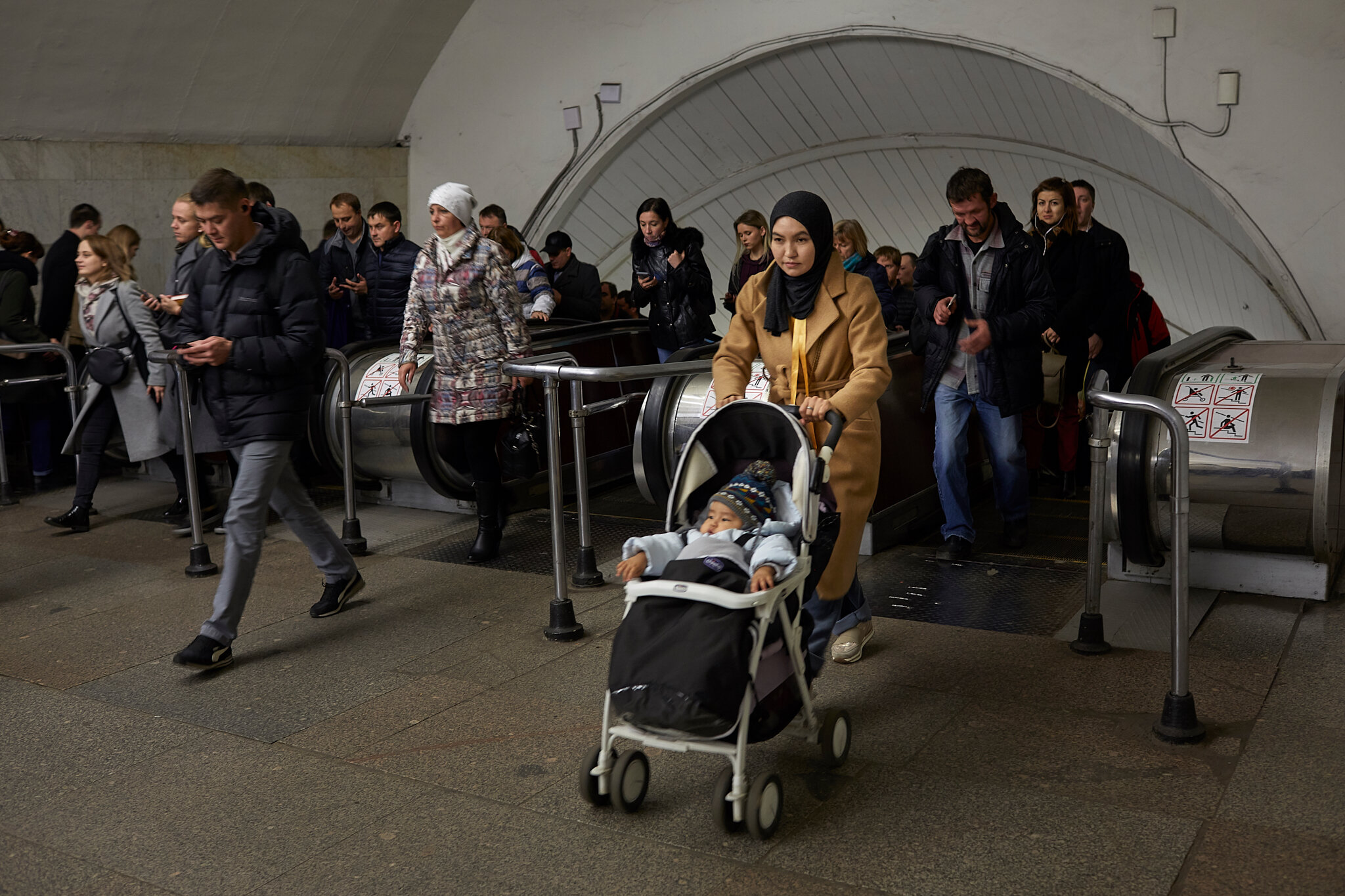 Russia, Moscow, 08/10/2019. Shahrizada Adanova (26) with her 8-months old son Kagan Adanov rides the Moscow subway to her show-room. Shahrizada came alone to Moscow when she was 19. She worked as a cleaner in the big department store, then as a help