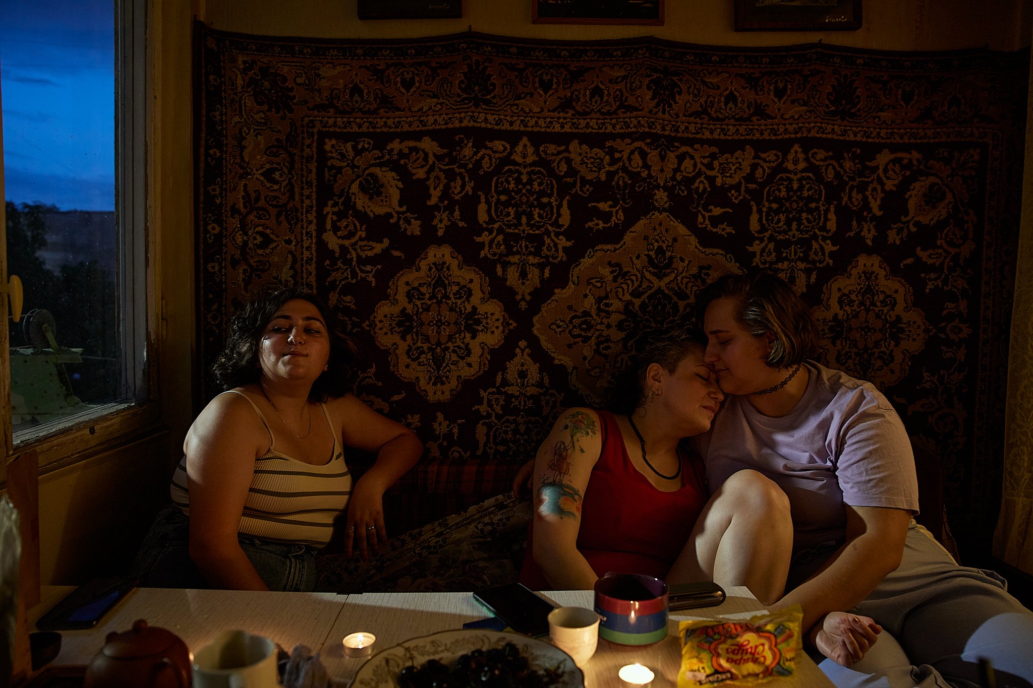  Armenia, Yerevan, 01/07/2022. Emma (left), Elena (middle) and Tatiana (right) are sitting at the table after the dinner party. Tatiana (32) is an openly bisexual woman from Rostov-on-Don, Russia. One week after the outbreak of war in Ukraine she mov