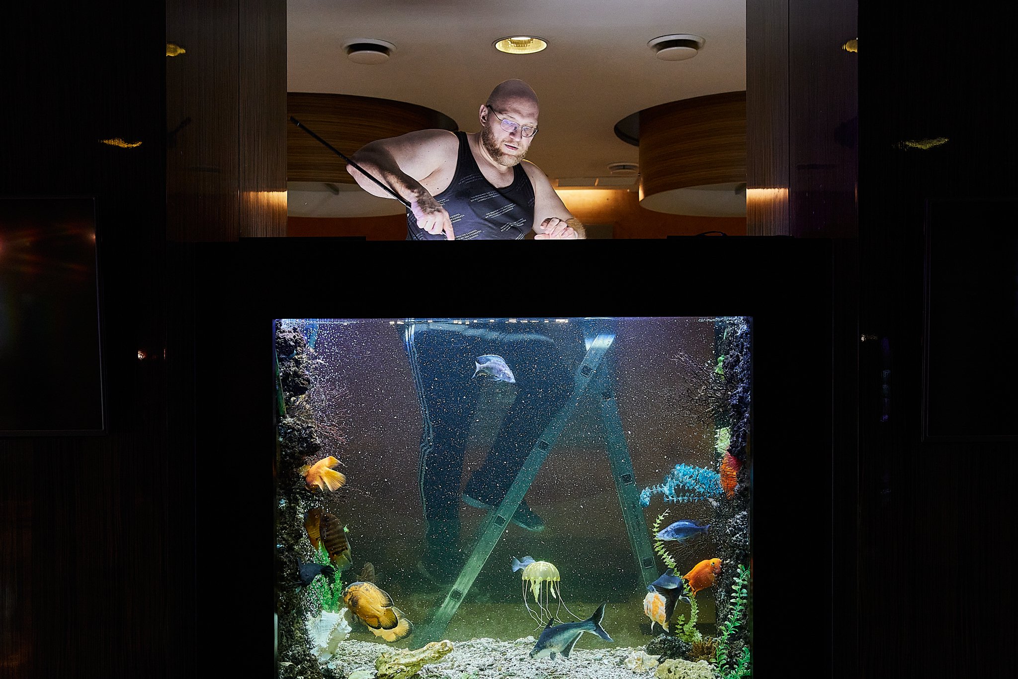  Russia, Yekaterinburg, 17/02/2022. Konstantin (40) is cleaning the aquarium. Konstantin realized that he admired men at the age of 12. He decided to talk to his mother and asked if she found out that his son was gay what would she do. She answered t