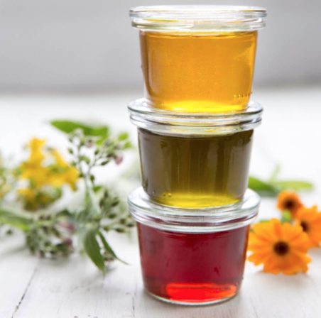 Three herbal-infused olive oils: (Top-Bottom) Calendula ( Calendula officinalis ), comfrey ( Symphytum officinale )and St. John's wort ( Hypericum perforatum ). They look tasty, but don't eat! They are for external use only.