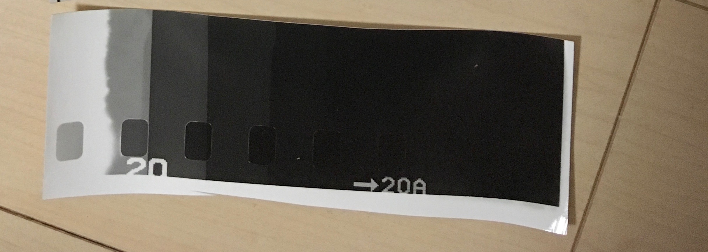 blank piece of film enlarged onto paper to determine min time for max blacks. 2s, 4s, 6s, 8s, 12s etc. Around 12 seconds we're reached max black. Longer exposure will not give deeper blacks. This means that exposing my negatives onto this paper for 12 seconds should be enough to give nice deep blacks. 