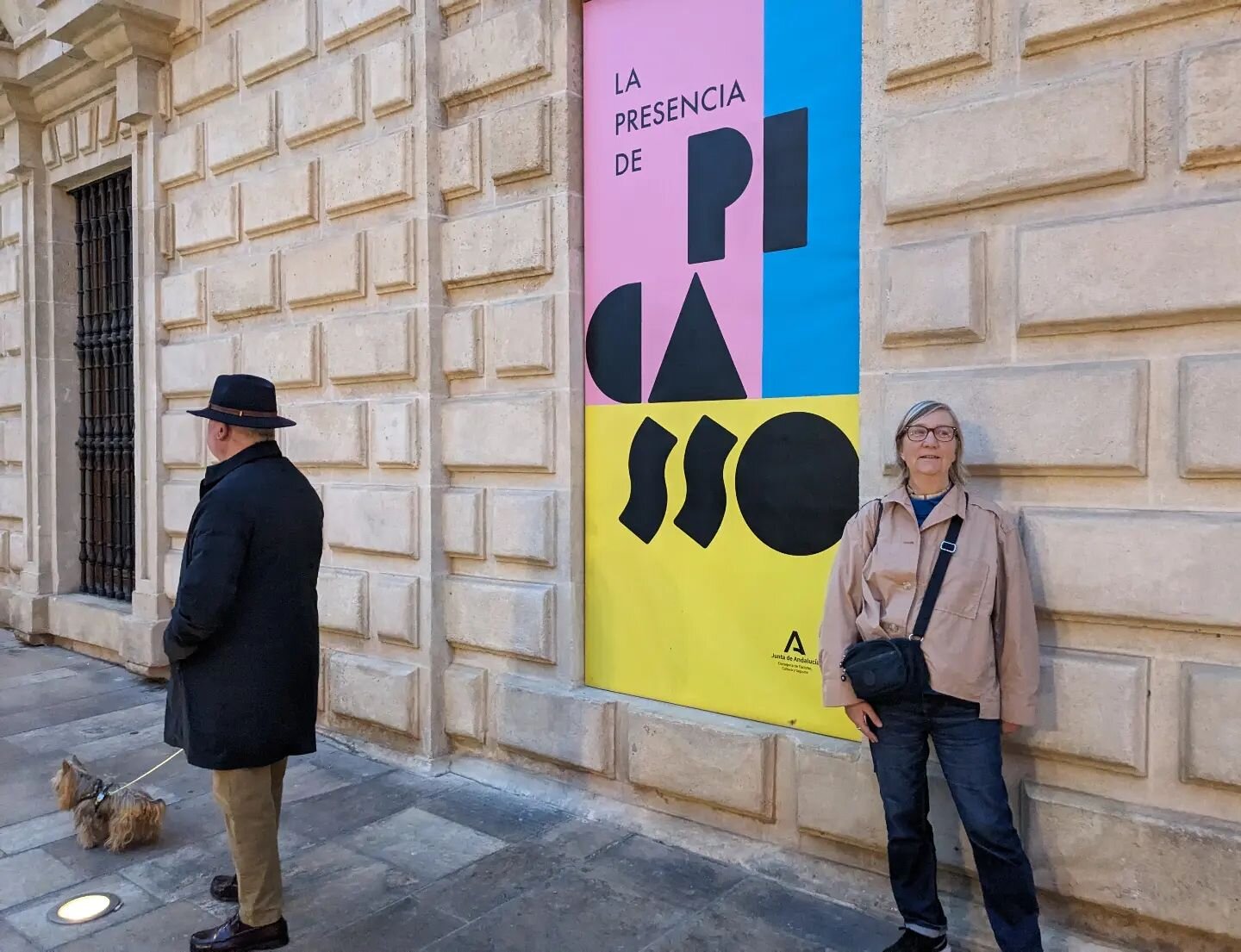 Woman posing with Picasso poster alongside man and dog. Lots to see in M&aacute;laga! Apparently Picasso said he'd never come back here after he left. Off to the @museopicassomalaga this morning. Interested to see what's there.

#sunny #break #picass