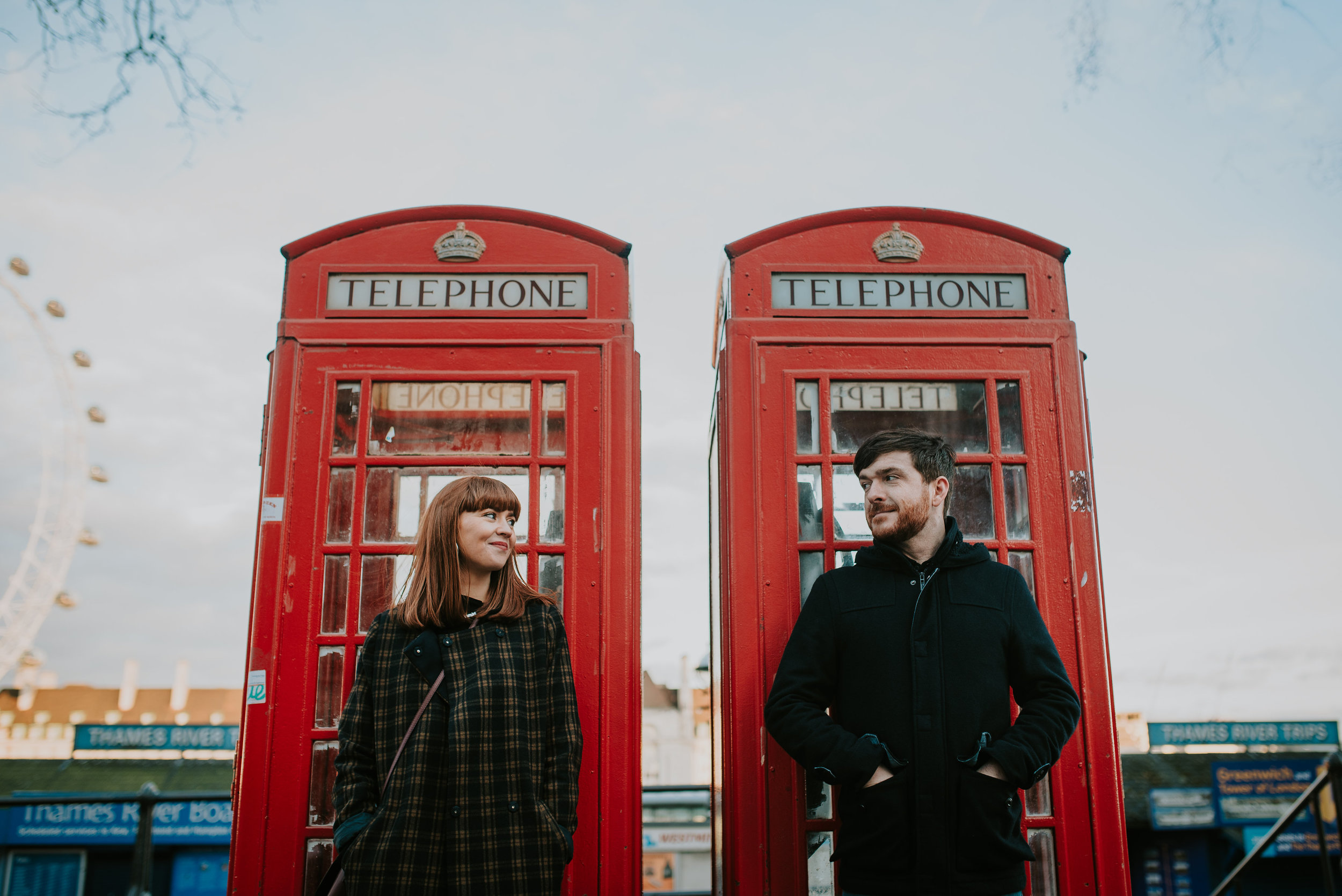 Engagement photo with red phone boxes London