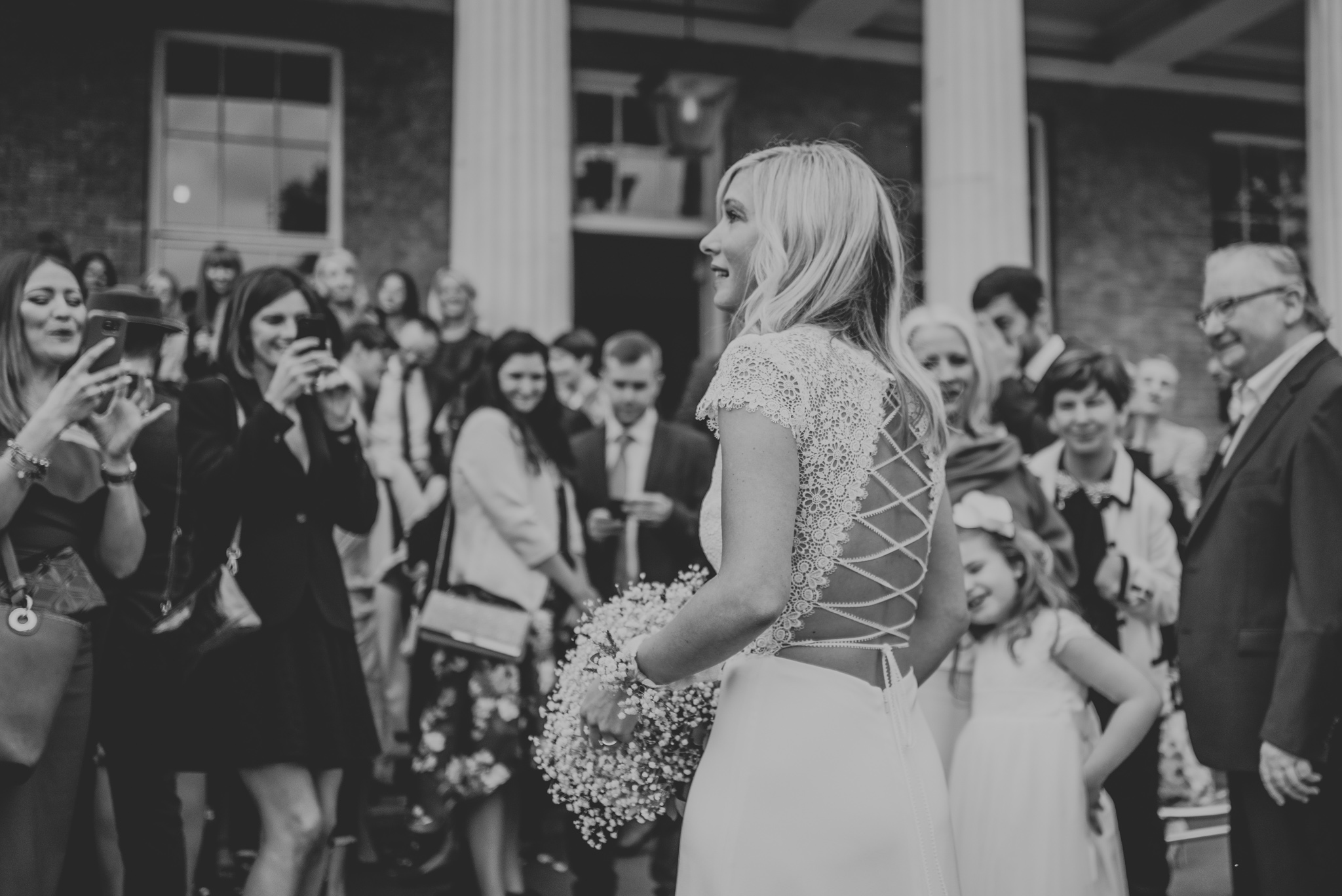 People taking photographs of bride wearing Anais Anette Savannah wedding dress