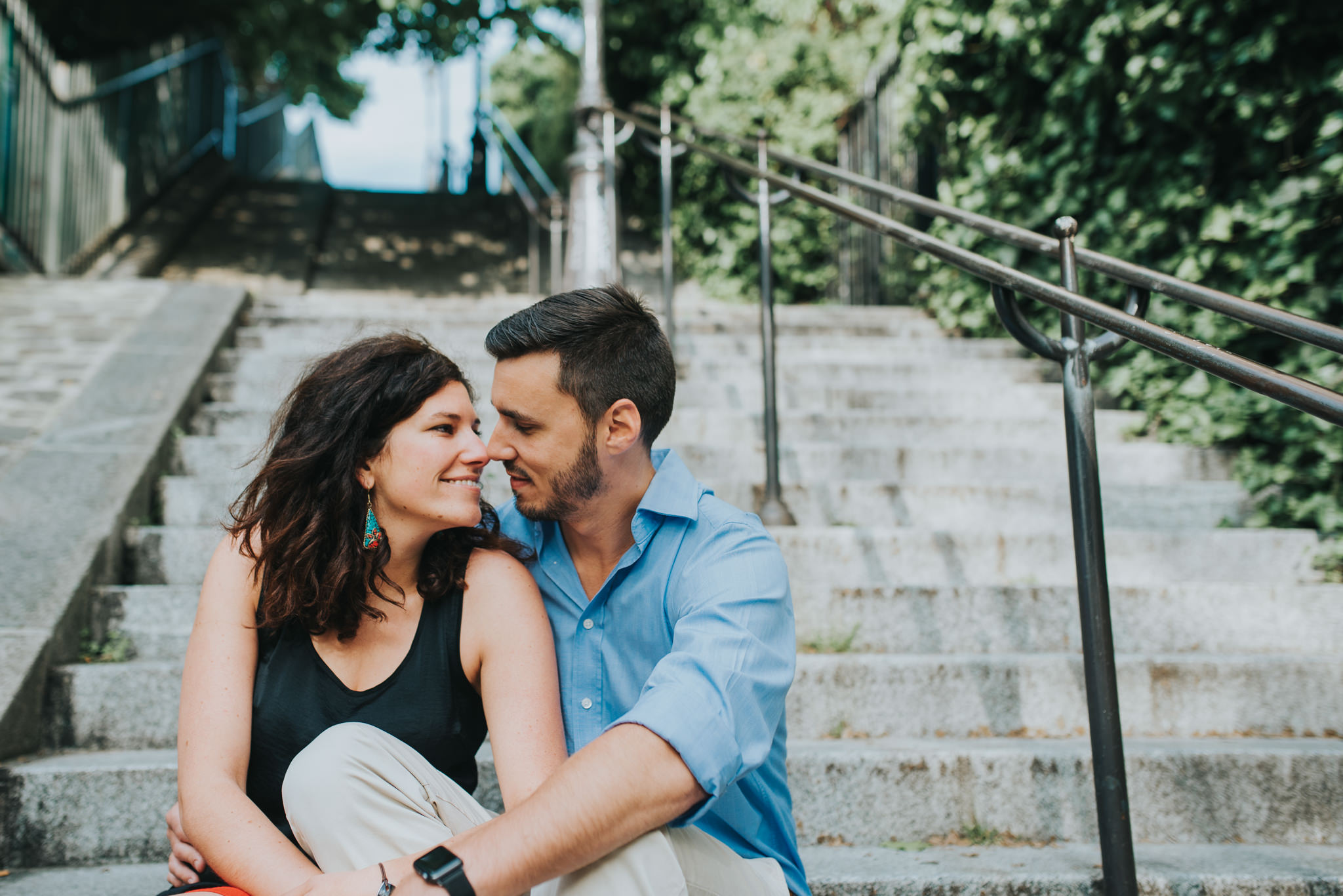 couple in love sitting on steps in Montmartre, Paris