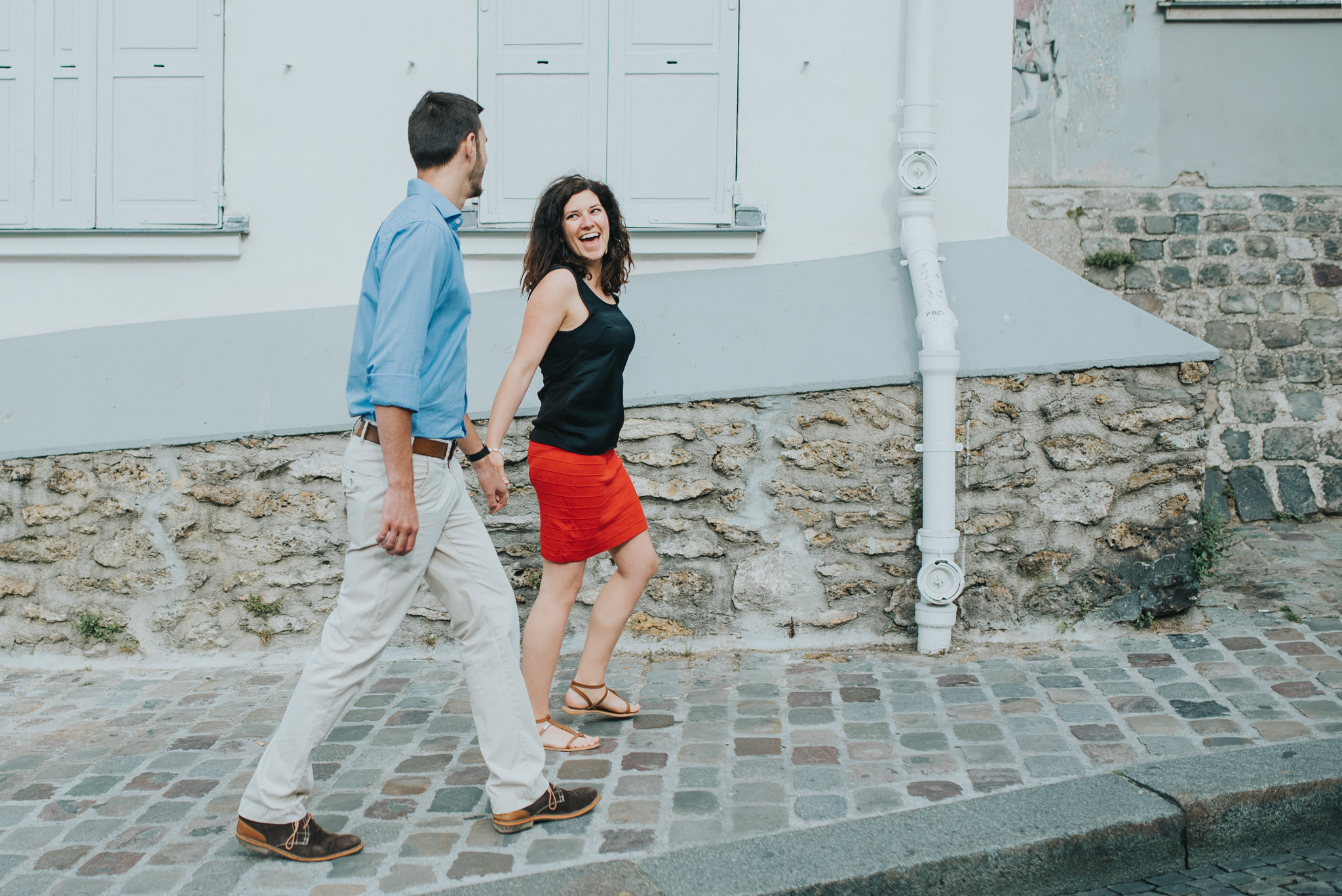 Paris engagement photography couple in love walking on Montmartre street