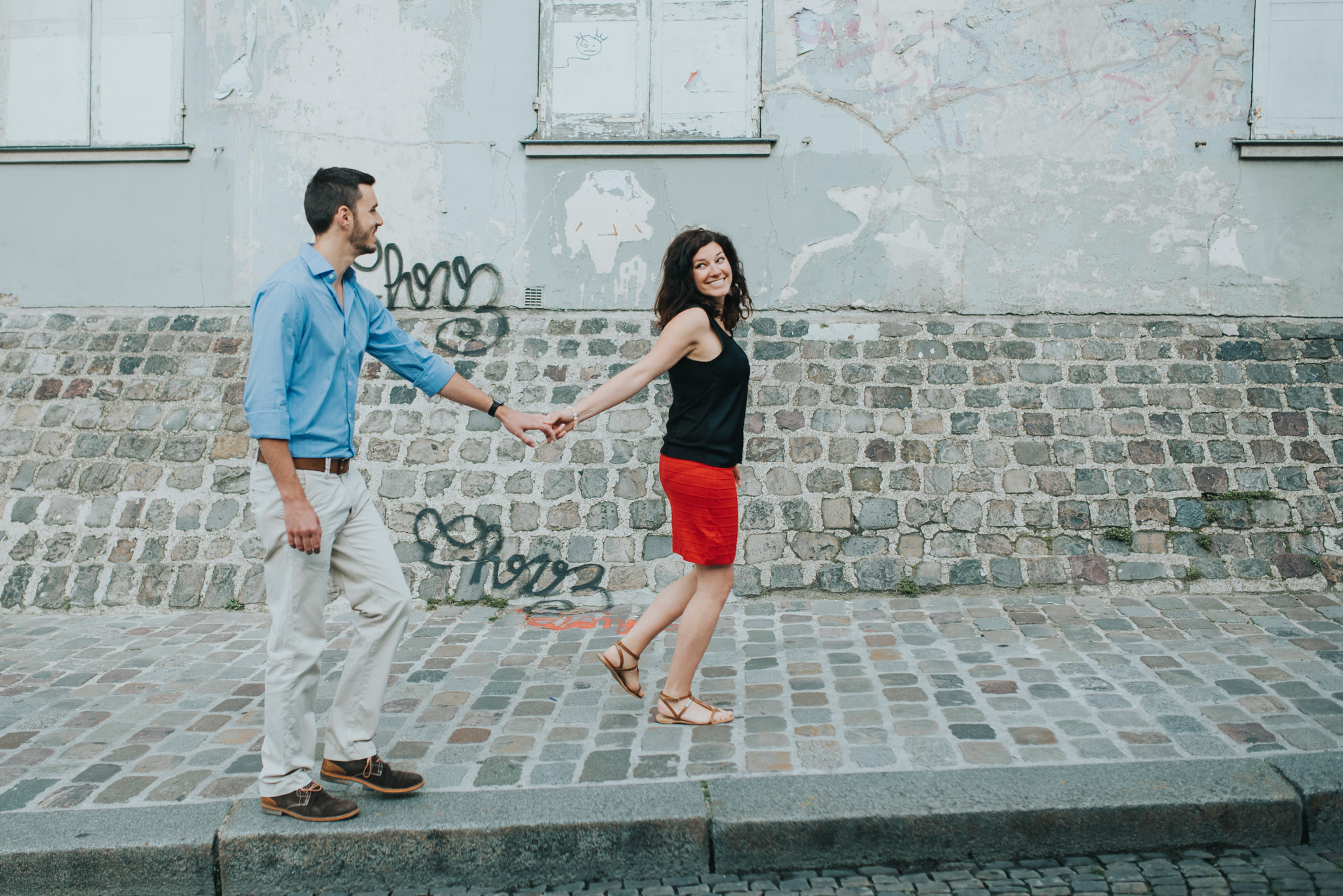 Paris engagement shoot couple in love walking on Montmartre street