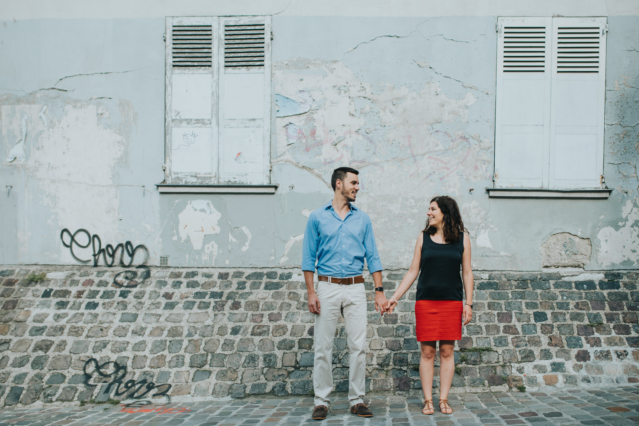 engaged couple in love standing on Montmartre street
