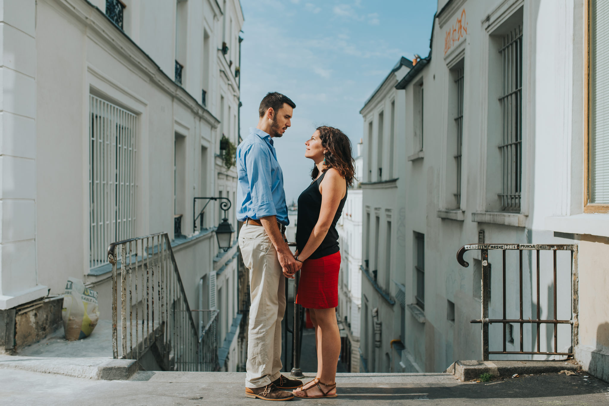 engaged couple in love standing in front of Parisian architecture