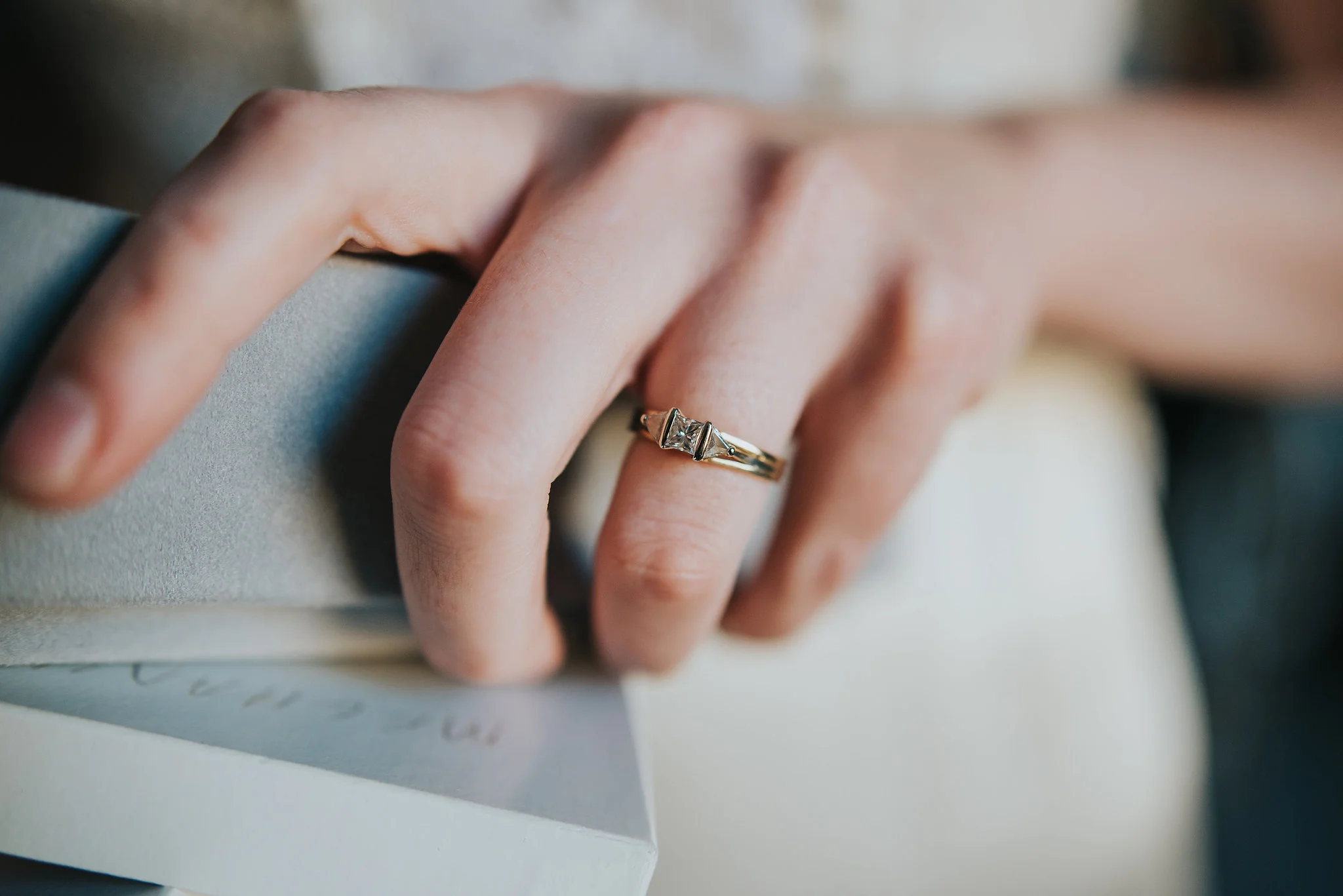 Close up of antique engagement ring on bride's finger
