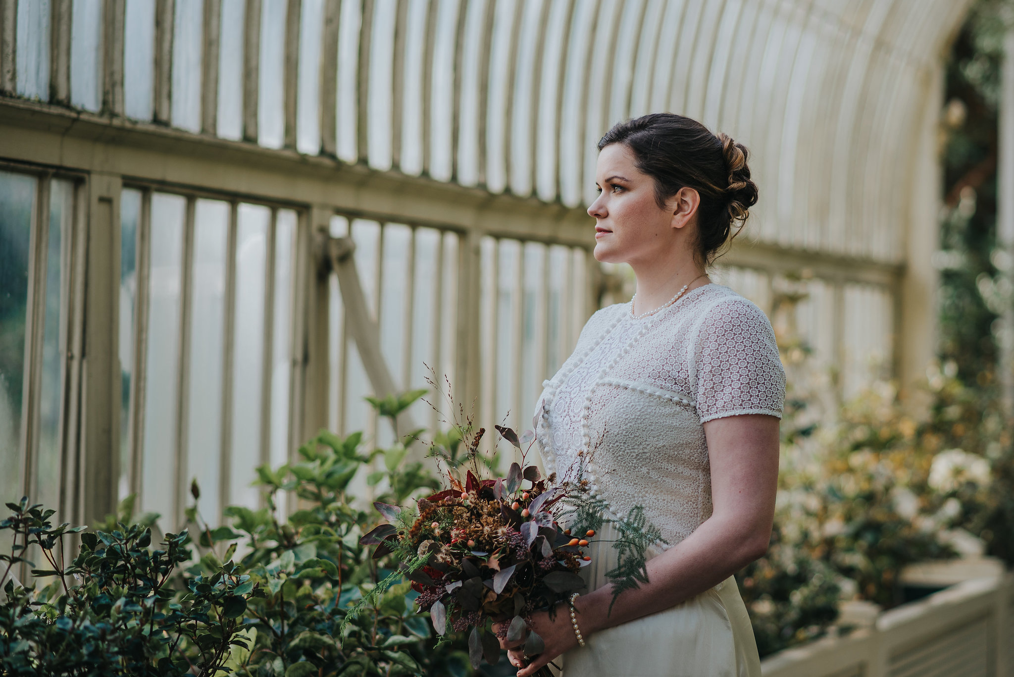 Bride holding bouquet in greenhouse at the Botanic Gardens Dublin on her wedding day