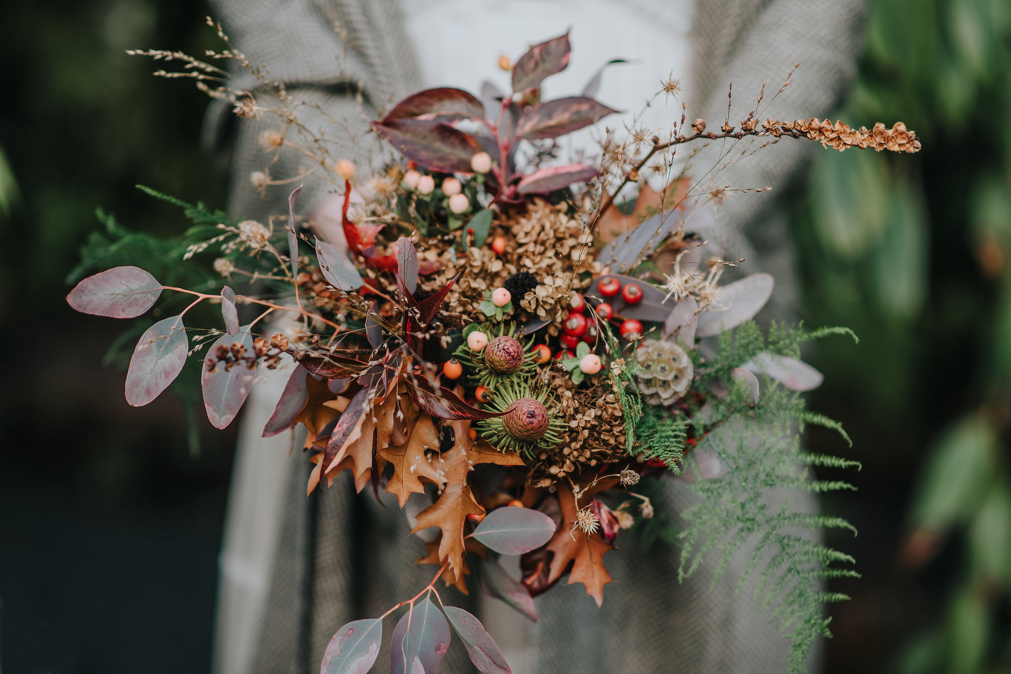 Close up of bridal bouquet with autumn flowers and leaves