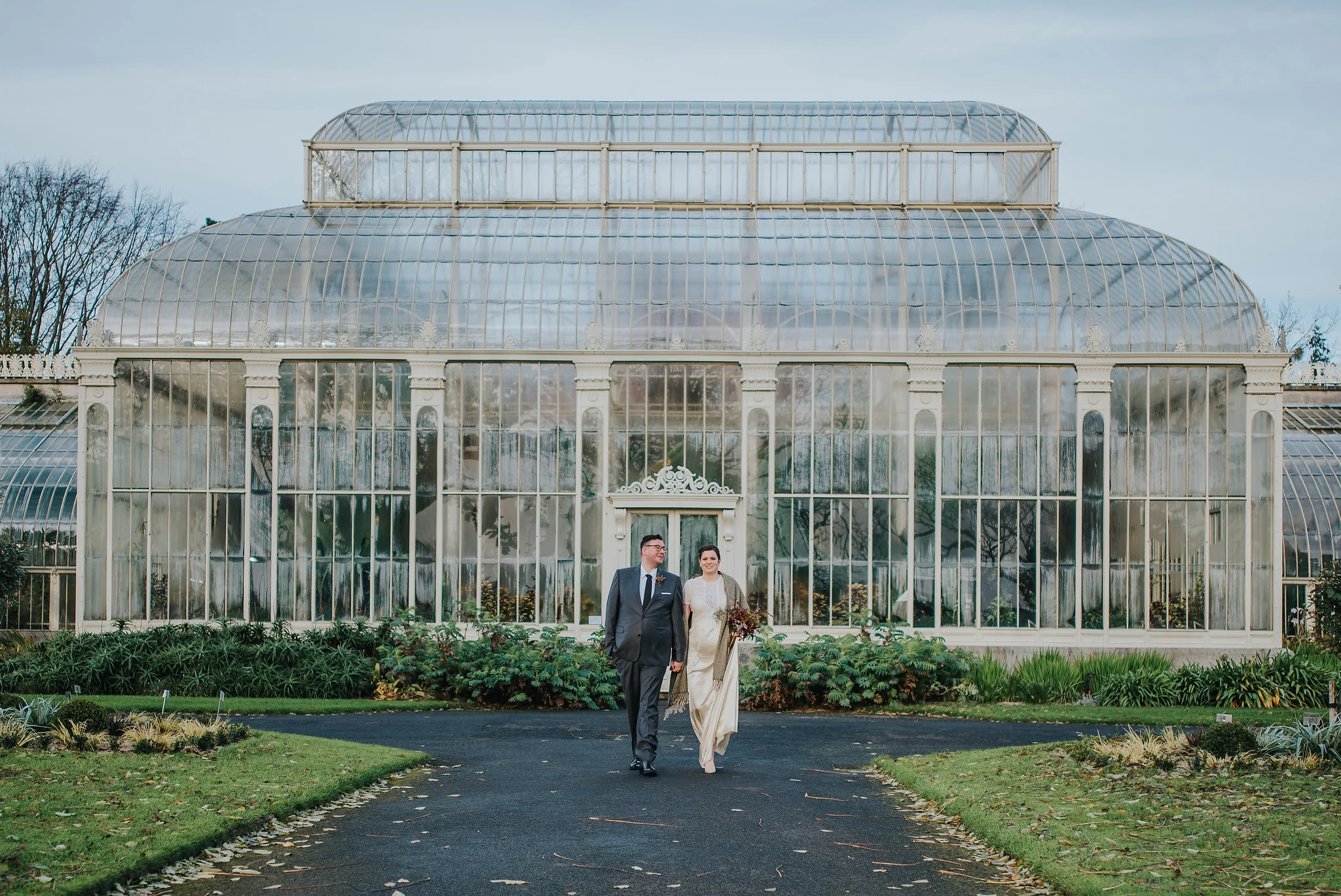 bride and groom walking in the Botanic Gardens Dublin on their wedding day