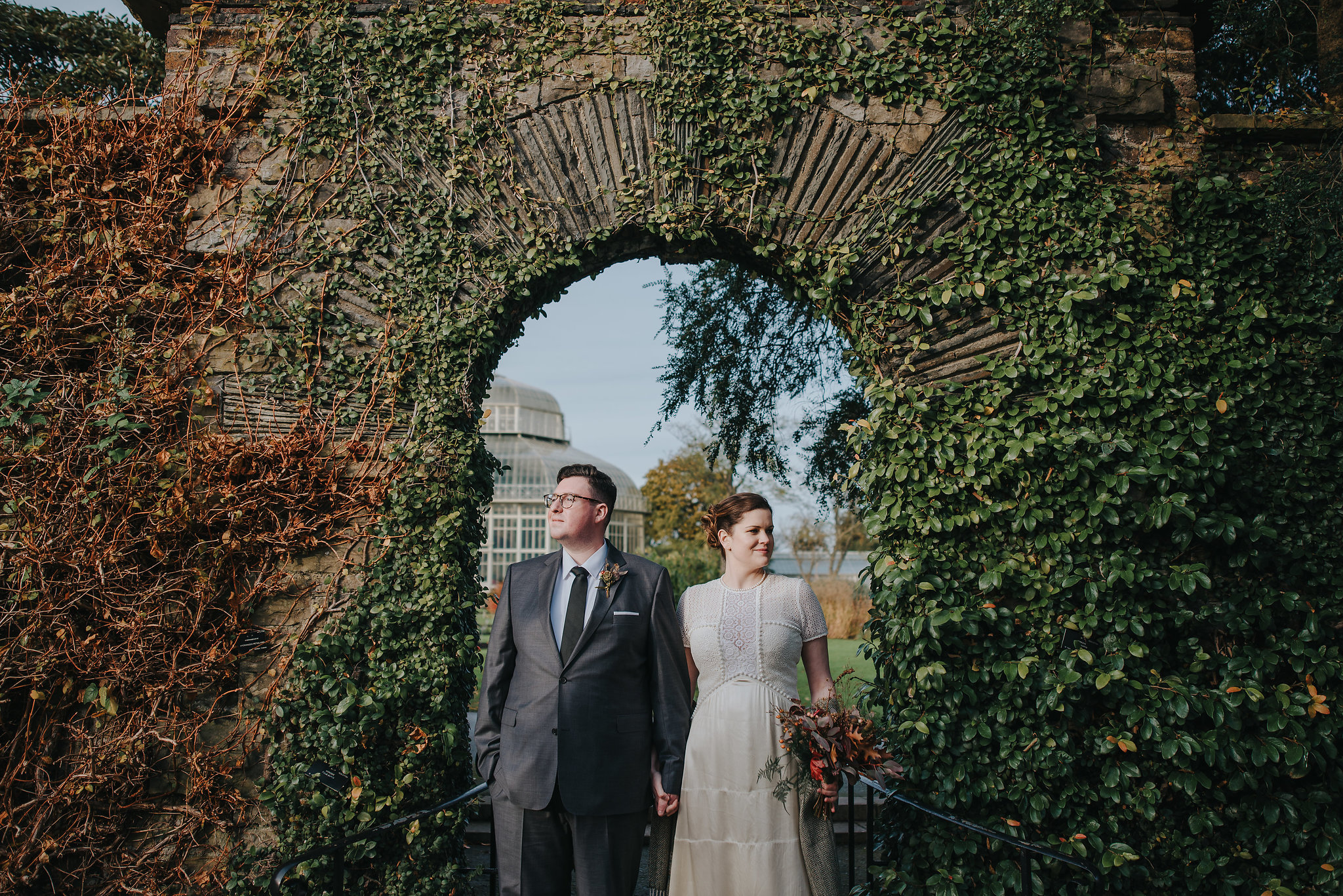Bride and groom standing in archway at Botanic Gardens