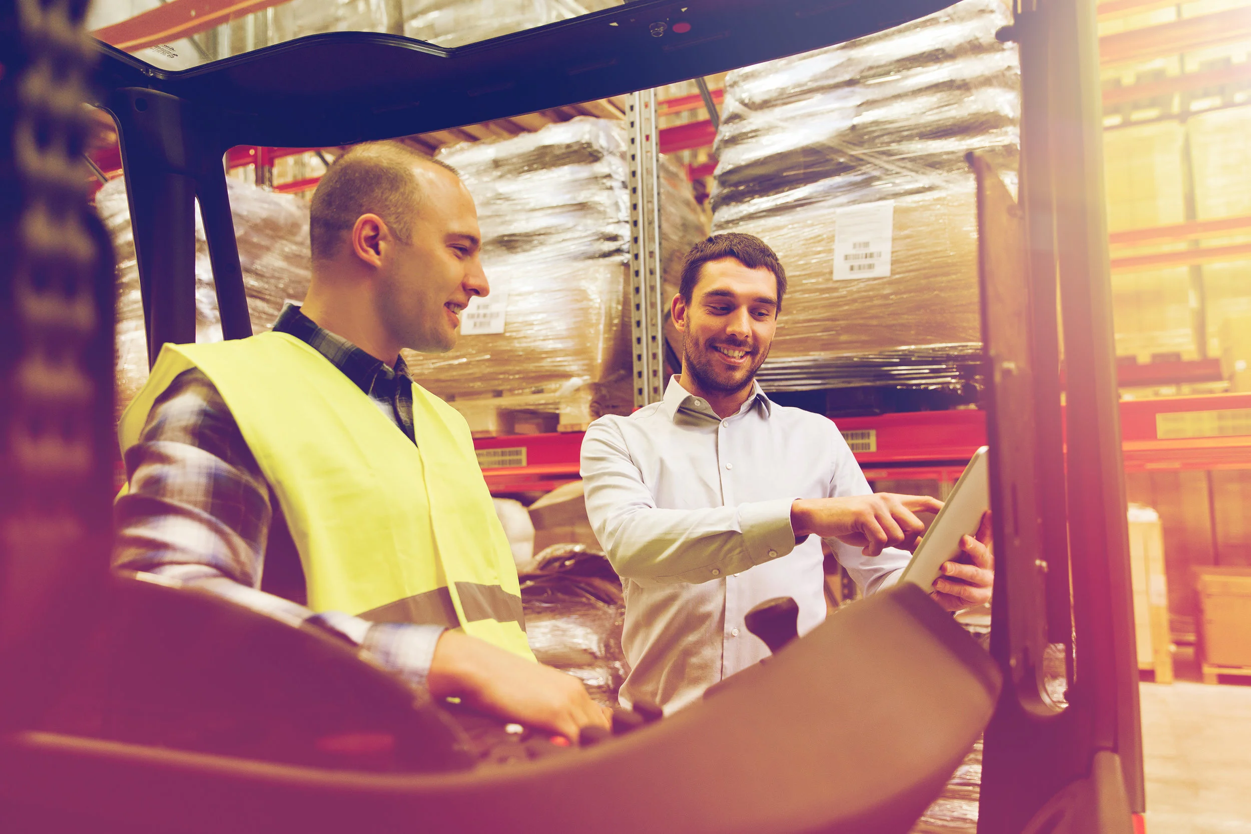 happy-men-with-tablet-pc-and-forklift-at-PR2CLBG.jpg