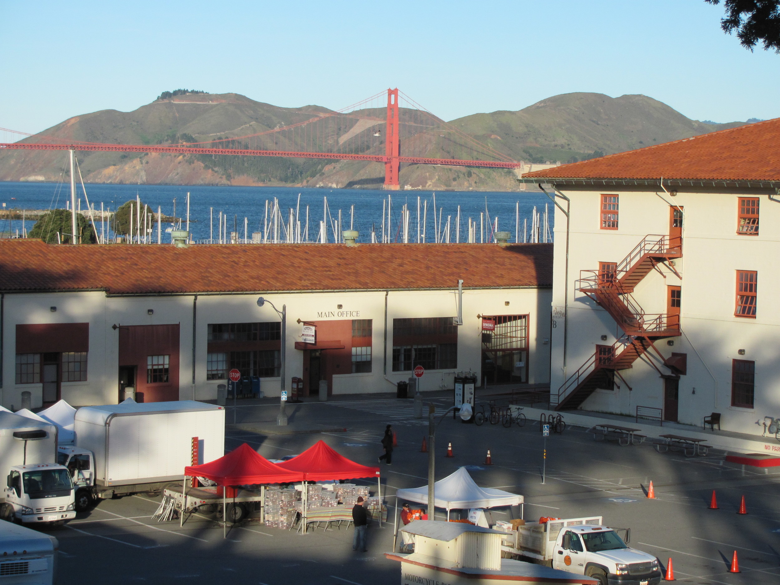 Setting up the Fort Mason Center Farmers' Market with a view of Golden Gate Bridge