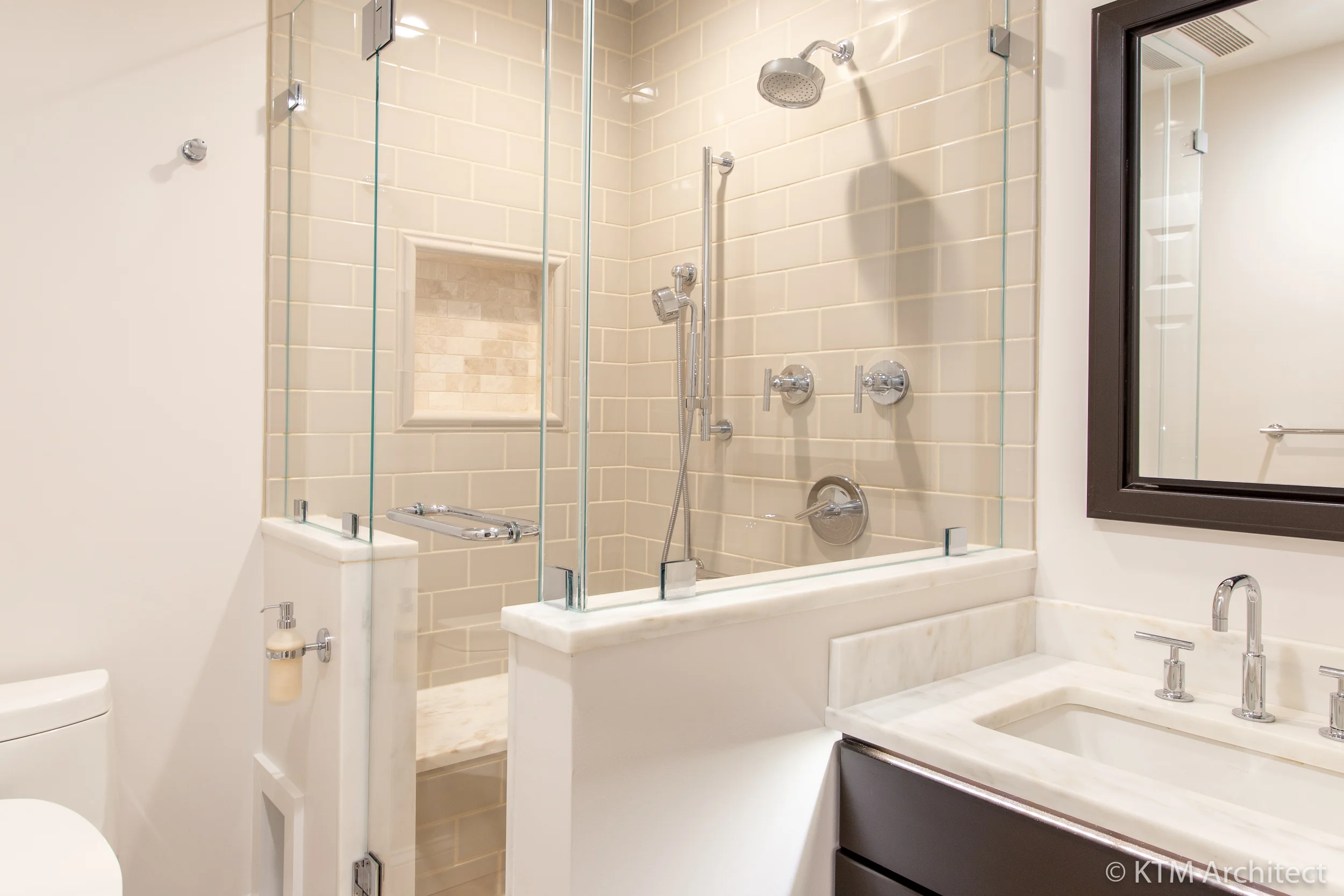 Off the main hallway there is an additional bathroom with walk-in shower and bench seating: this bathroom was built with the needs of an aging parent in mind and is adjacent to a bedroom.