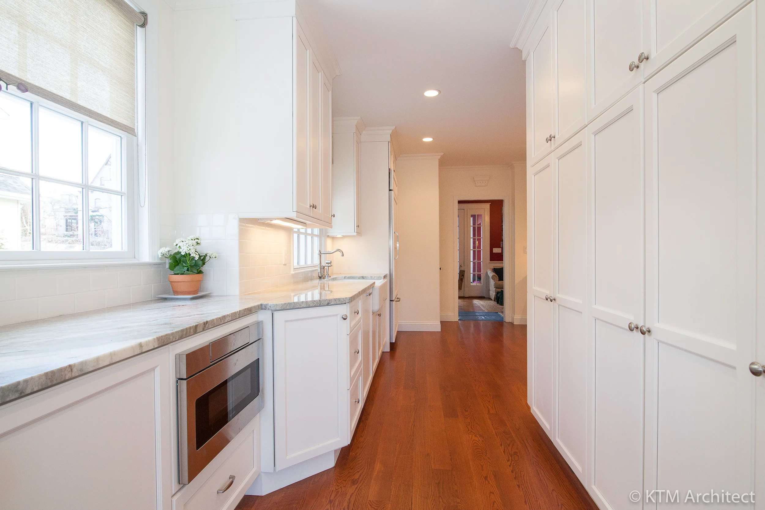 The floor to ceiling pantry wall in a simple shaker style provides much needed storage.