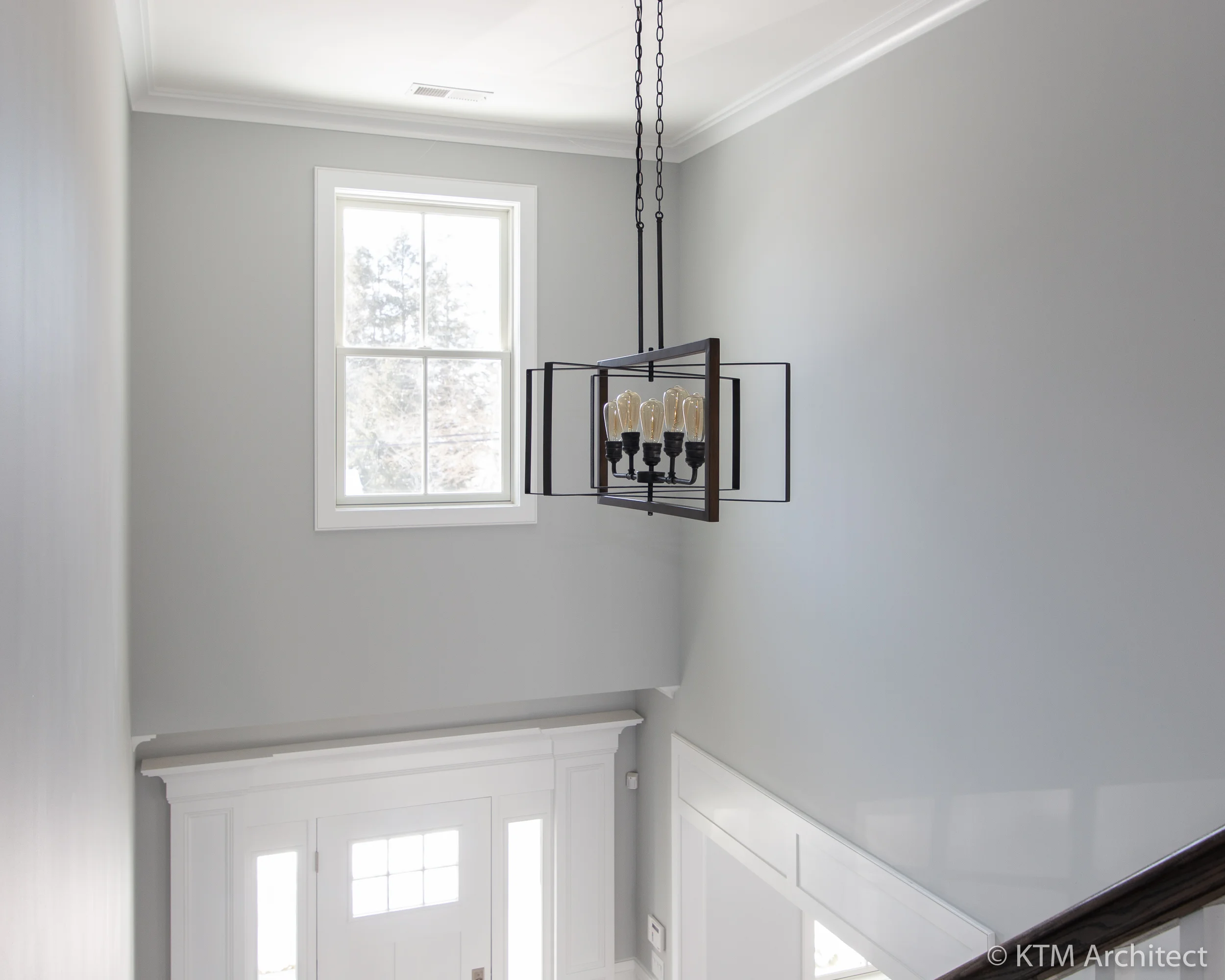 A view of the entry chandelier from the second floor landing.