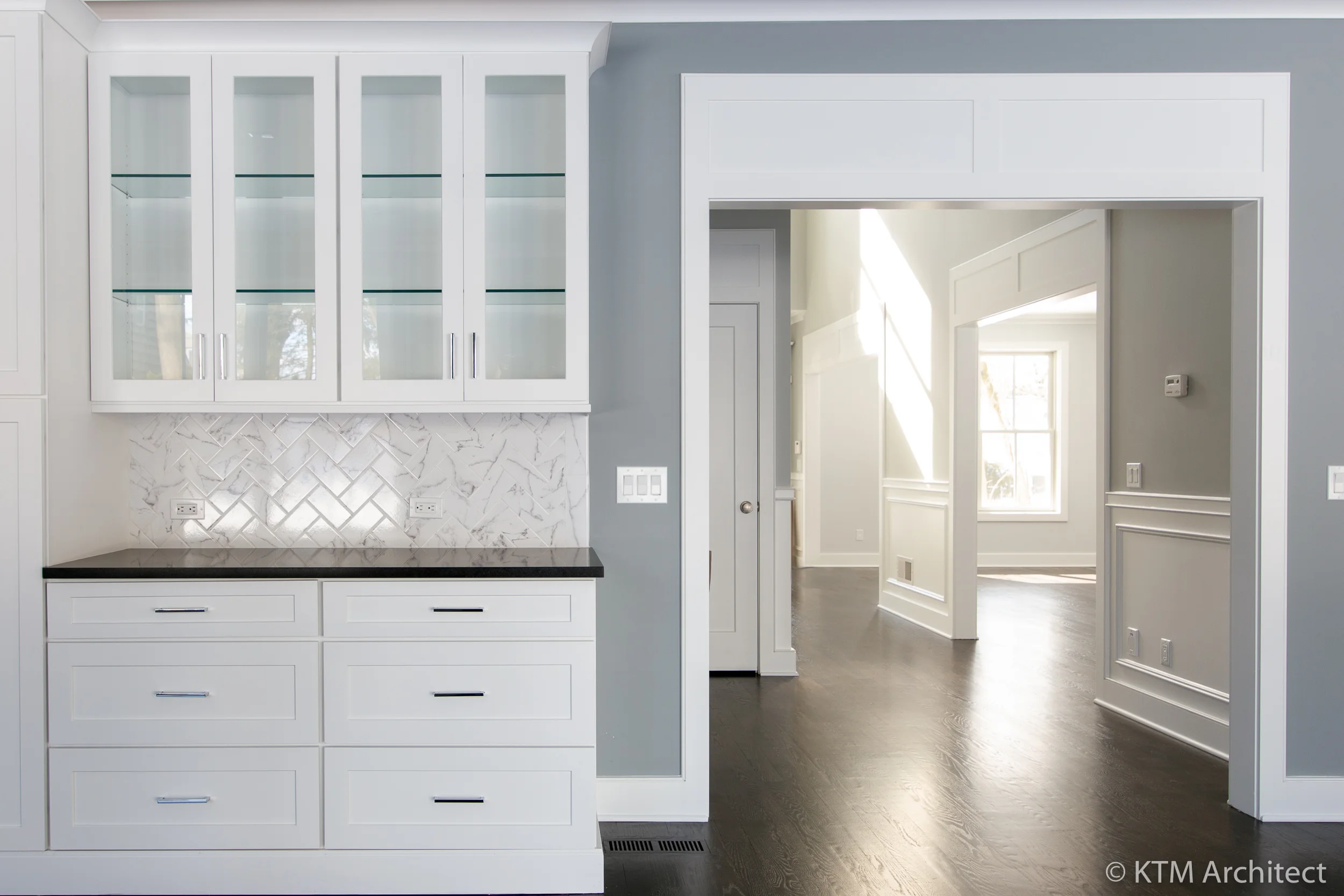 A closer look at the cabinetry and flow through the entry.