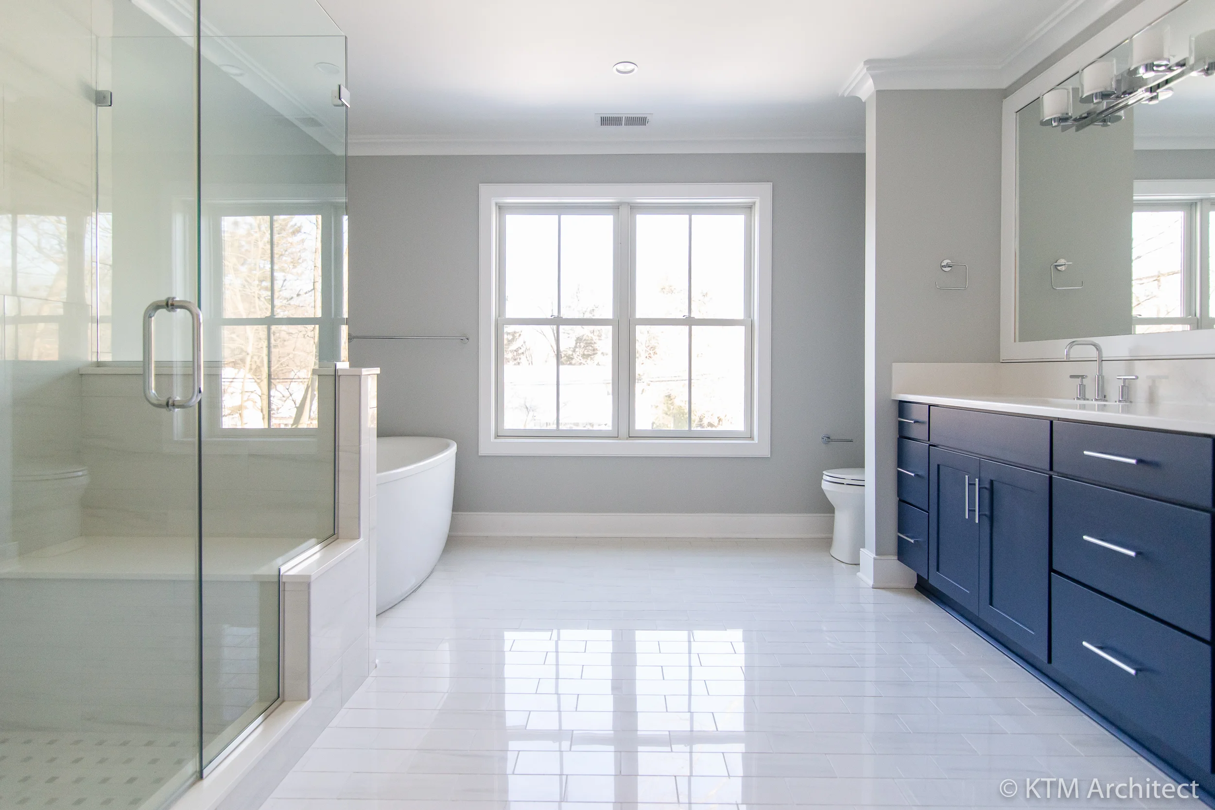 The spacious master bath features a soaking tub, large shower with seating bench, and a bright and lively double-vanity with plenty of storage.