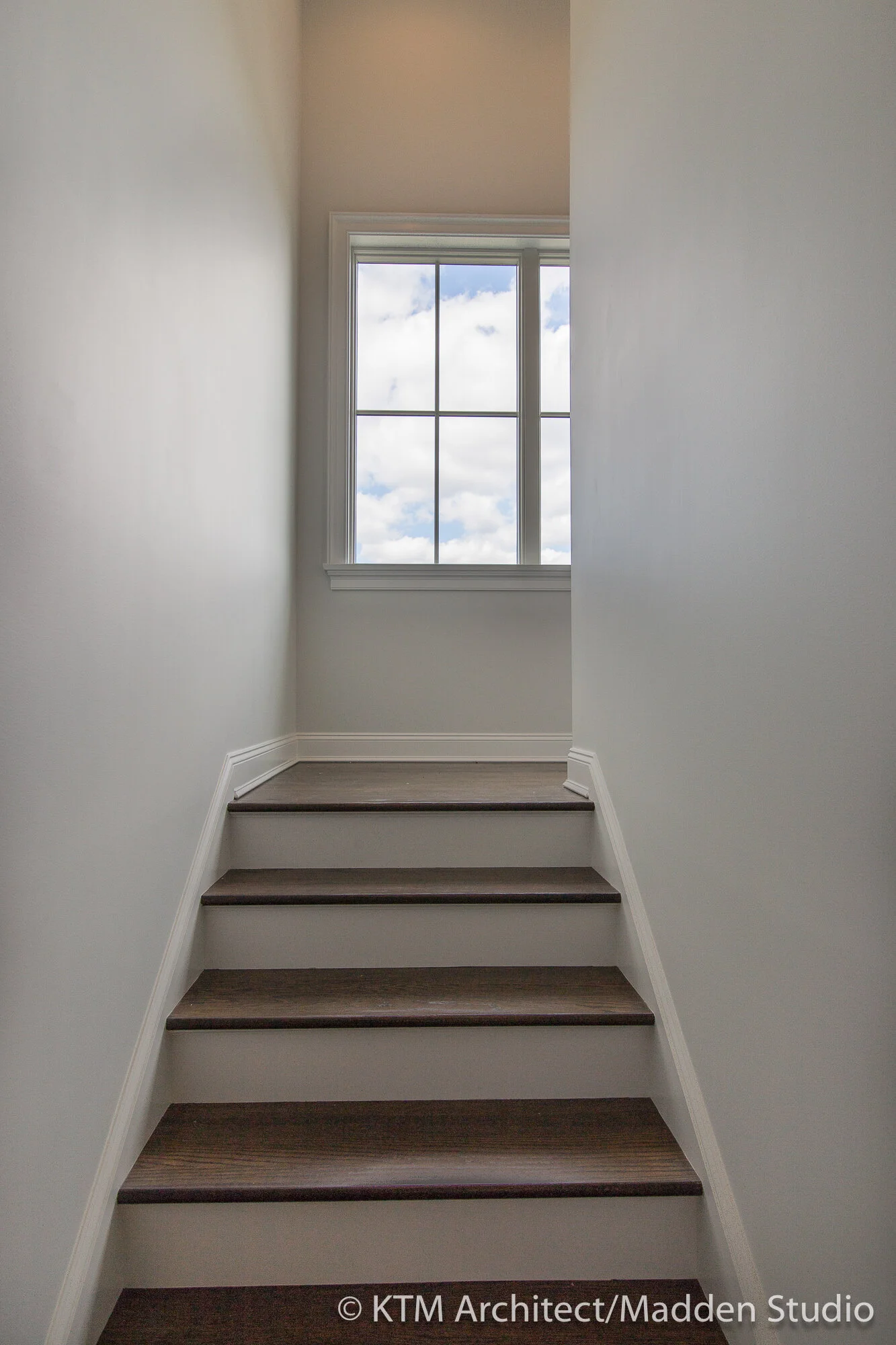 The large windows light the stairway and provide expansive views.