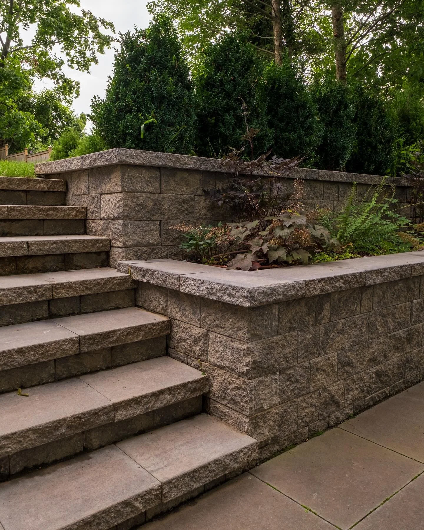 Terraced area leads to a sunken bluestone patio, where these homeowners have their fire pit. #weekend #coolnights #spring #outdoors #outdoorliving #winetime @ktmarchitect photos by @maddenstudio