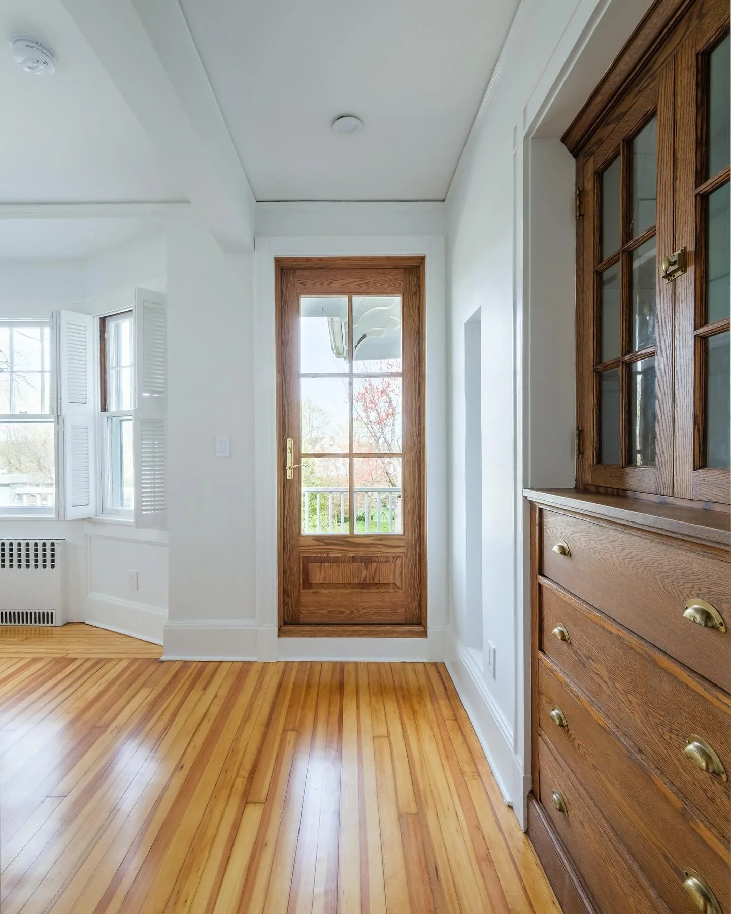 Preserving the historical details such as the oak door and built-in were part of our mission as we transformed this Larhmont Victorian.  We removed a wall between a narrow hall and adjacent room, refinished the original floors and painted the space i