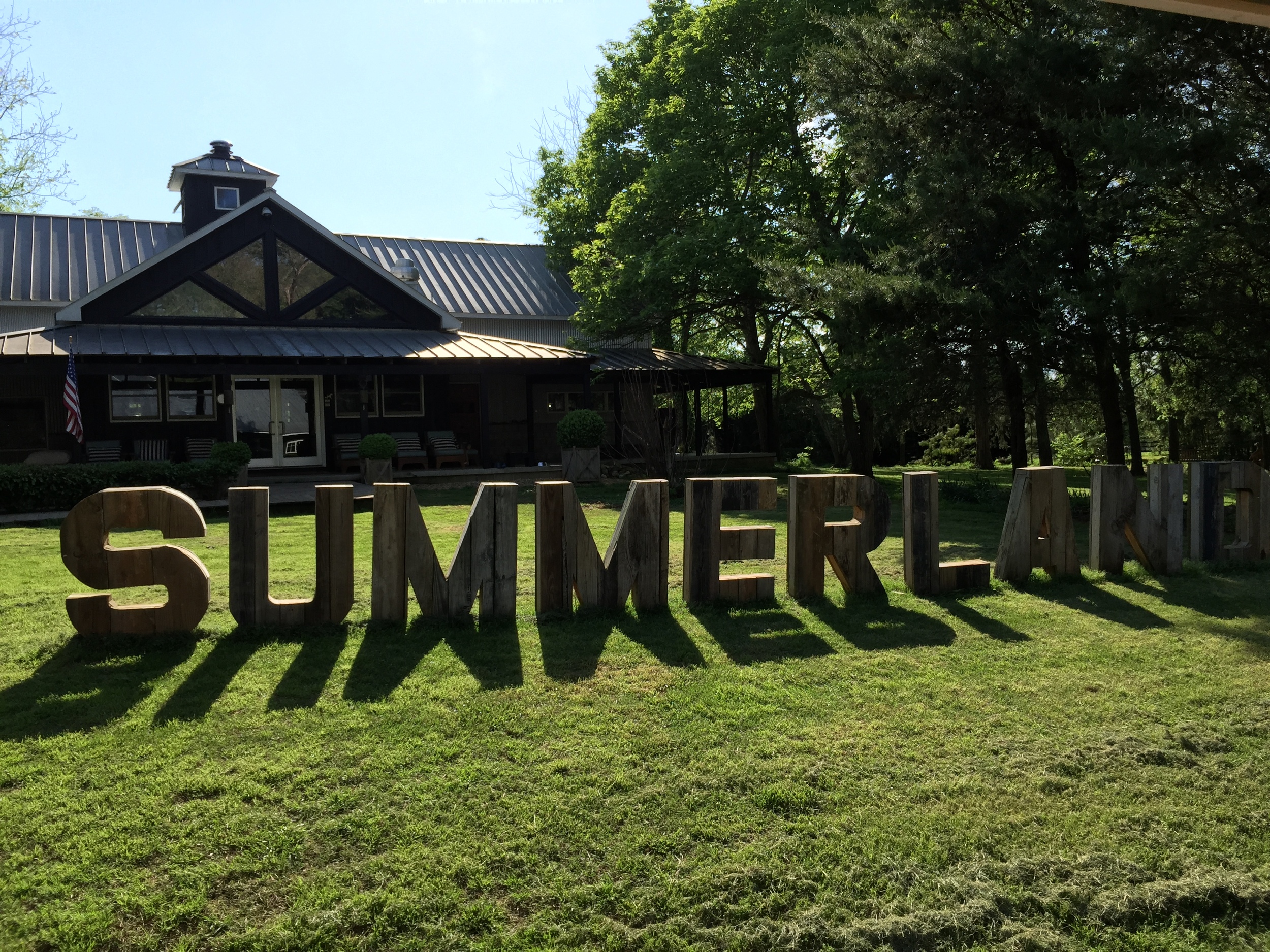 Wood block letters spelling out Summerland in front of building