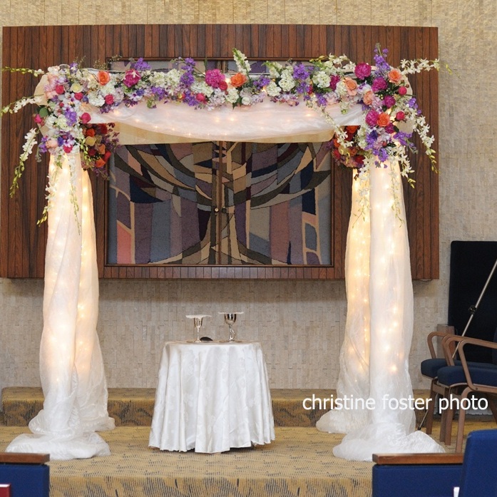 Chuppah - Fabric Pole Chuppah with Substantial Flowers, String Lights Throughout, and Medium Fabric (1,500)