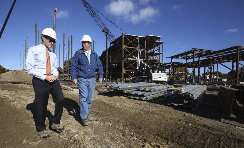 Salem News - Ken Yuszkus/Staff photo - Mayor Michael Cahill, left, walks with Robert Gilchrist, the contractor's project site manager, during a tour Friday of the construction site for the new Beverly Middle School. The school is expected to open in the fall of 2018.