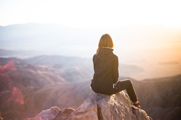 https://freedesignfile.com/404119-woman-sitting-on-the-peak-watching-the-sunrise-stock-photo/