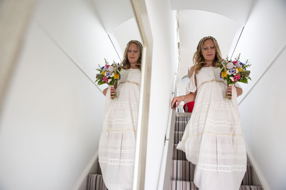 Bride descends stairs at Boho Cornwall.jpg