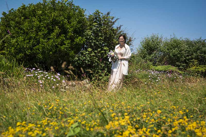 bride in cornisg flower meadow.jpg