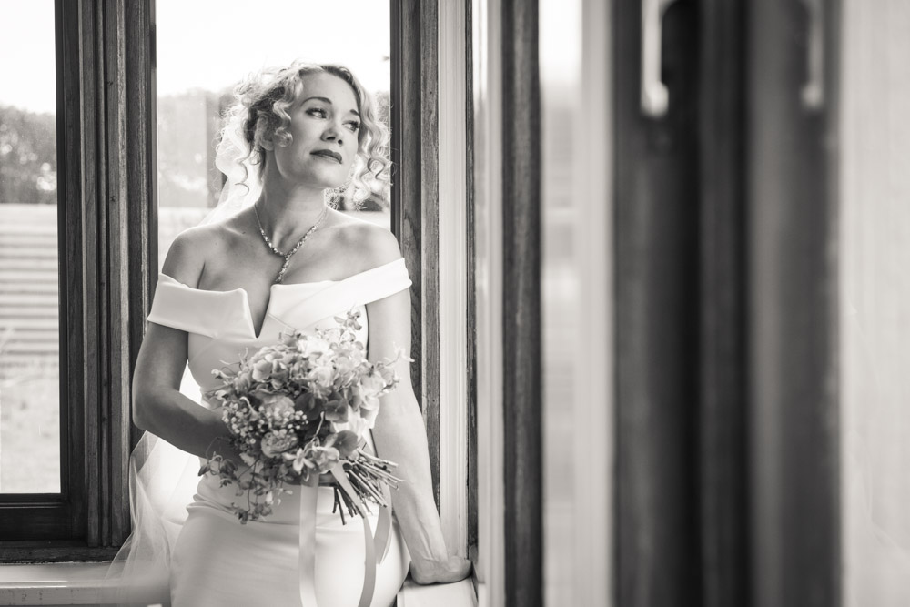 beautiful bride by window boho cornwall.jpg