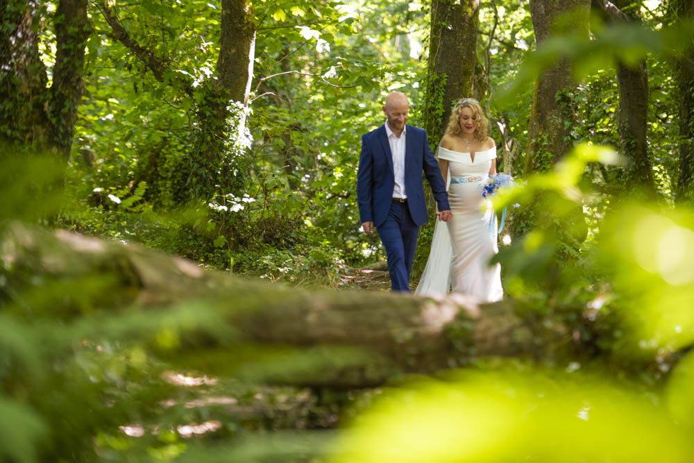 bride and groom walk in woods.jpg