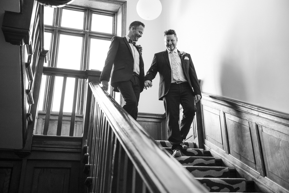 Same sex couple walk down stairs boho cornwall