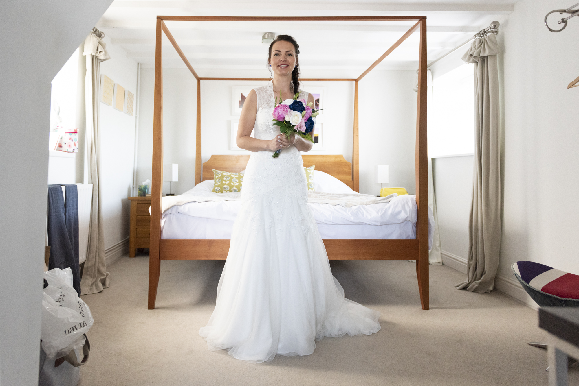 Bride in front of four poster bed