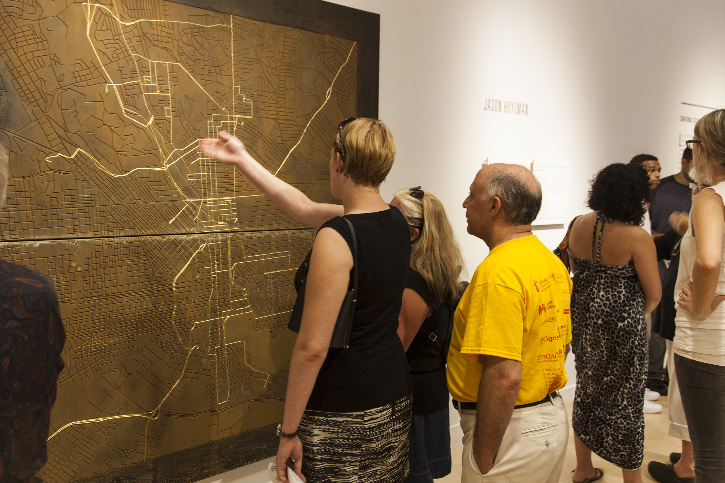   Visitors examining Hoylman's map of Station North and greater Baltimore.  
