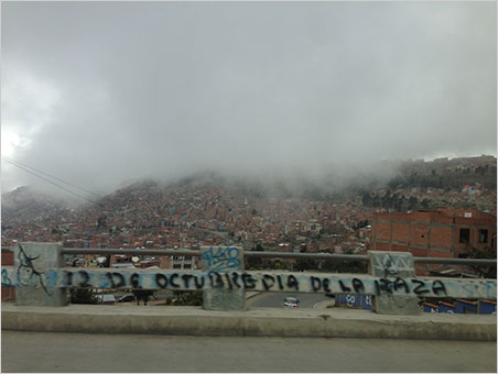 The fog of war. This guardrail graffito pays homage to the uprising of the people (la raza) that began October 12, 2003, leading to the resignation of President Gonzalo "Goni" Sánchez de Lozada. Two years later, one of the protesters, Evo Morales, would be elected President. (Photo: Will Larson)