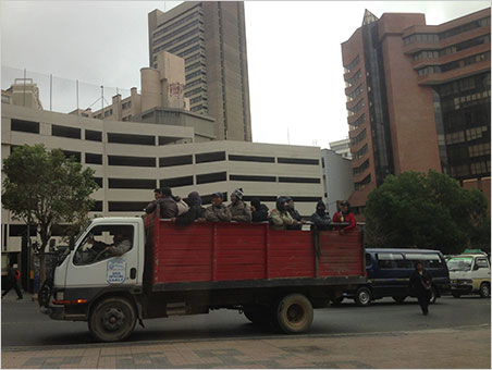 Truckin'. Landscape workers are transported through the concrete jungle of La Paz, a metropolis of about 2.5 million people. The worker in the middle wears a traditional Andeanchullo hat that could have been knit from the wool of the llama Will ate at lunch. (Photo: Will Larson)