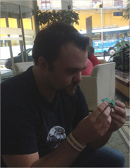 Holy Grail. Will Larson examines the phosphophyllite specimen in the lobby of his hotel. (Photo: Paparazzo)