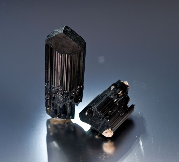 Two fine schorls; the best of our first day out at the Esmeralda Mine. A promising sign at the surface of what lies beneath. Larger crystal on the left is about 6 cm. (Photo: Jason Stephenson)