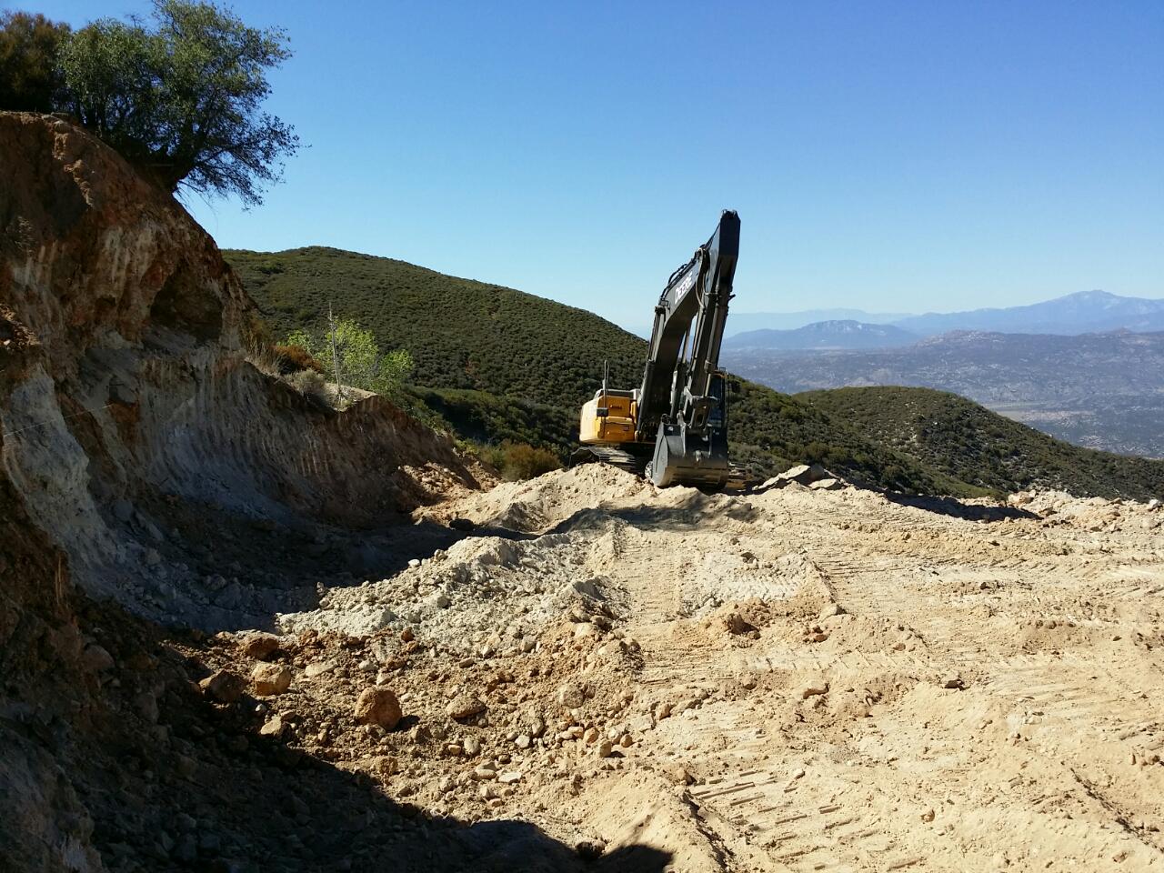 The Deere approaches the old workings and adit. Early August 2014. Click to enlarge. (Photo: Casey Jones) 